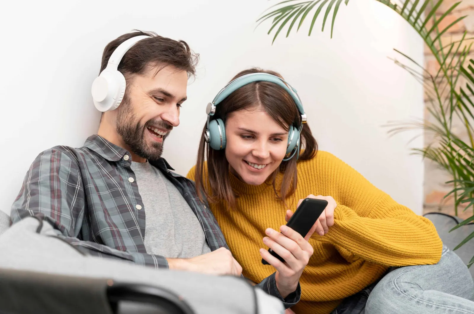 Koppel luistert samen naar Spotify op de bank